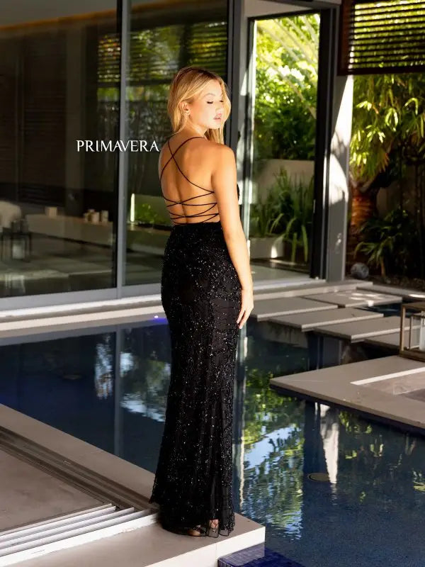 This Primavera Couture 4162 long prom dress is a perfect choice for any formal occasion. Featuring a fitted silhouette with a high slit, this stunning gown is adorned with sequin and bead detailing on delicate lace. The open back adds a touch of elegance, making it ideal for pageants and formal events.