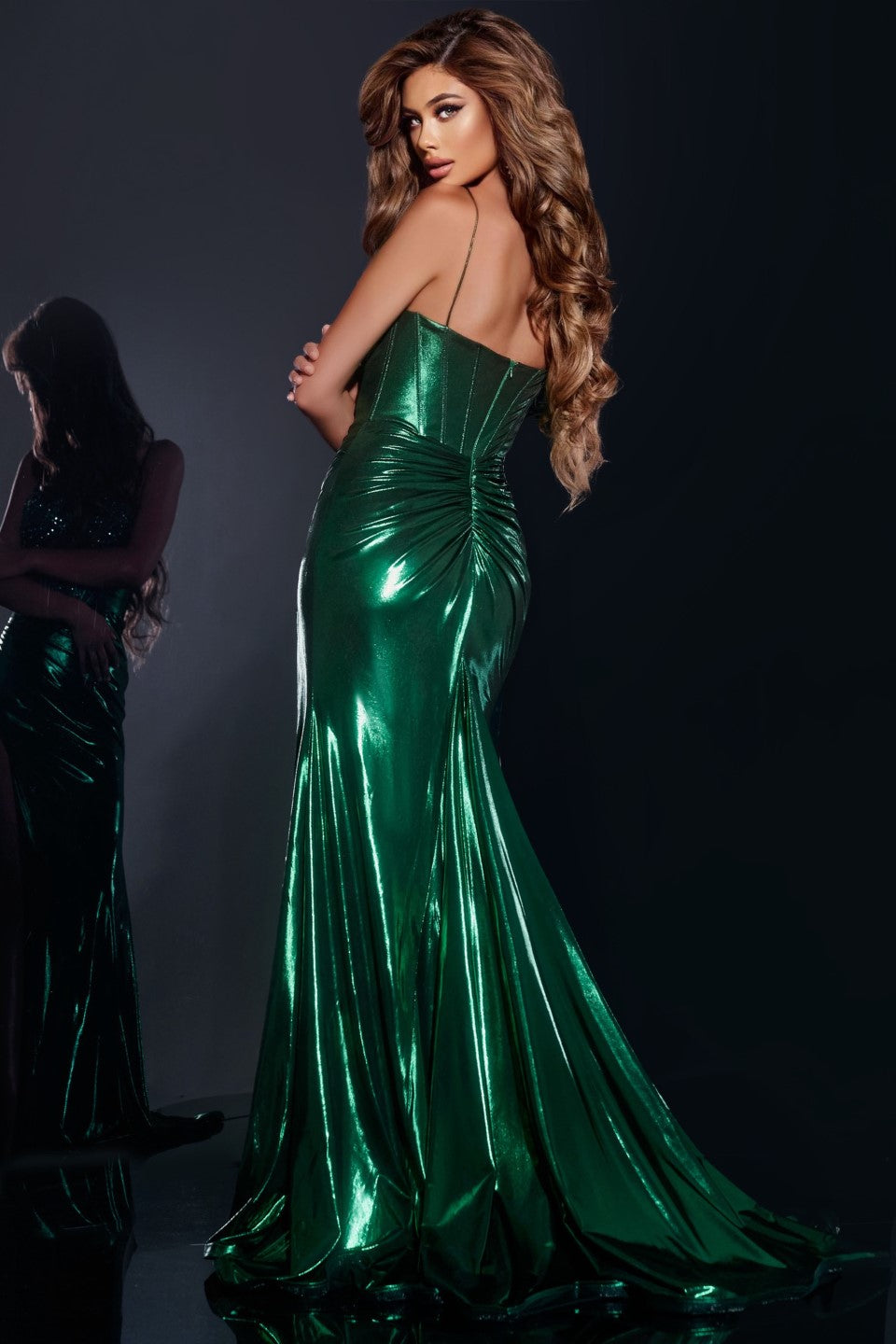 This Jovani 42336 metallic long dress is beautifully designed with a ruched sheer crystal corset and a flowing skirt, perfect for prom or any formal evening event. The metallic fabric adds a touch of shine to the elegant look. Make a statement with this expertly crafted gown. This stunning gown features a floor-length silhouette with a dramatic thigh-high slit, adding a touch of glamour to any event. The fitted bodice is adorned with intricate beadwork, creating an eye-catching sweetheart neckline. Spaghett