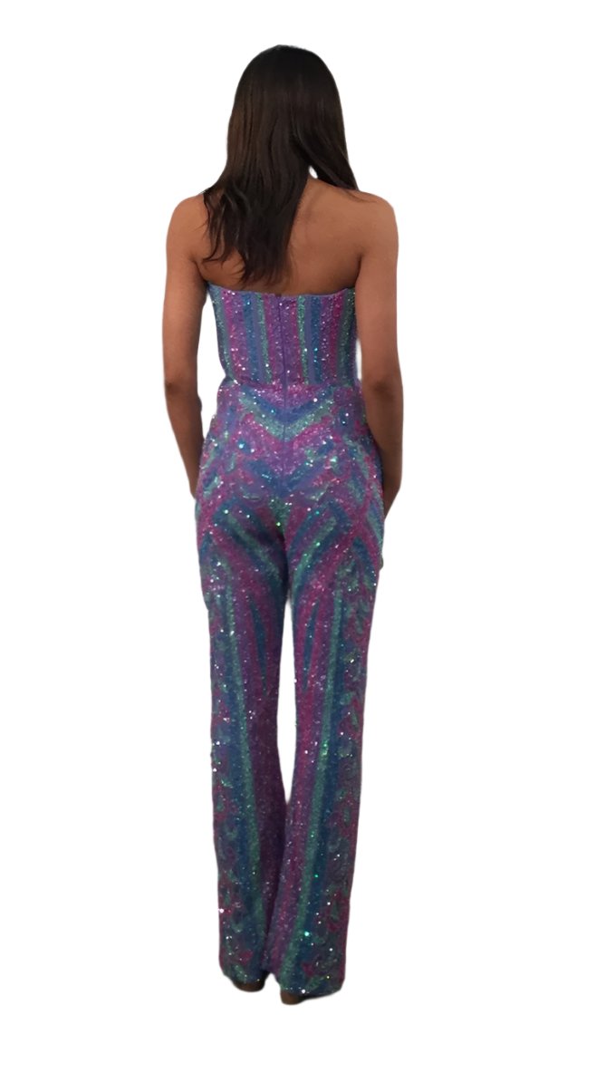 Dazzle in the Jovani 42597 Strapless Sequin Jumpsuit. This formal piece features a stunning sequin corset and delicate beading, perfect for pageants and special occasions. The strapless design adds a touch of fun and glamour. Elevate your fashion game with this exclusive and sophisticated ensemble.