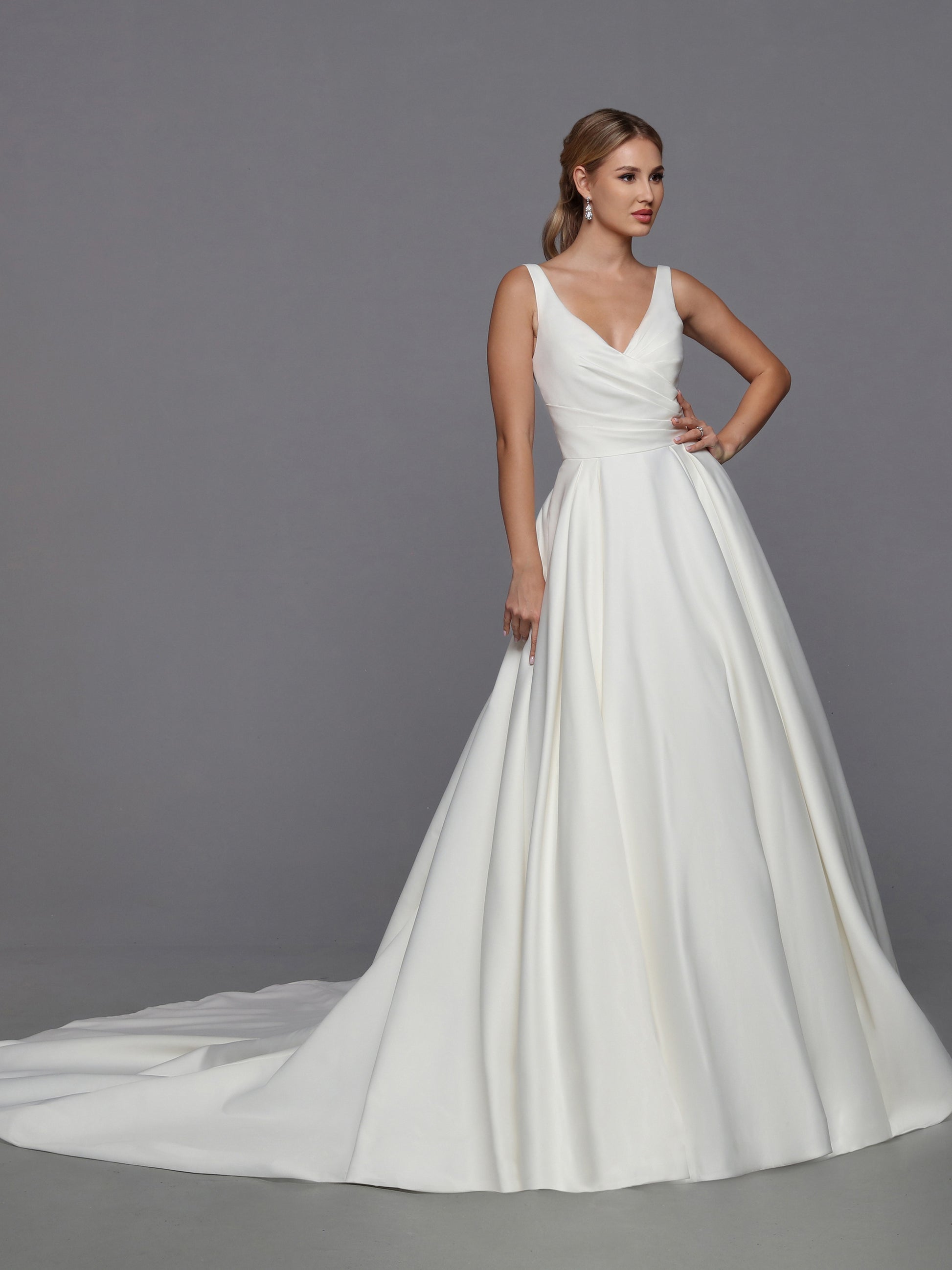 DaVinci Bridal 50766 A-Line Ballgown Satin Open Back Pockets Bow Train Wedding Gown. This feminine satin ball gown features lovely on-trend updates. The faux-wrap bodice has a waist-deep V-back accented with a removable oversized bow.