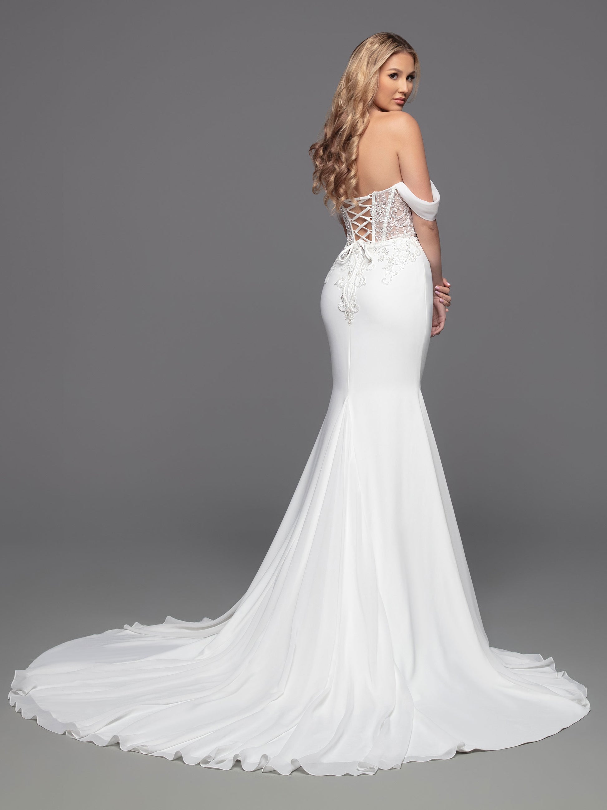 This Davinci Bridal 50803 Sheer Beaded Bodice wedding dress is a timeless choice for your special day. An elegant fit & flare silhouette with a corseted back, beaded appliques, and soft off-the-shoulder straps that flatter the neck and shoulders. The simple crepe skirt completes the classic look.  Sizes: 2-20  Colors: Ivory 