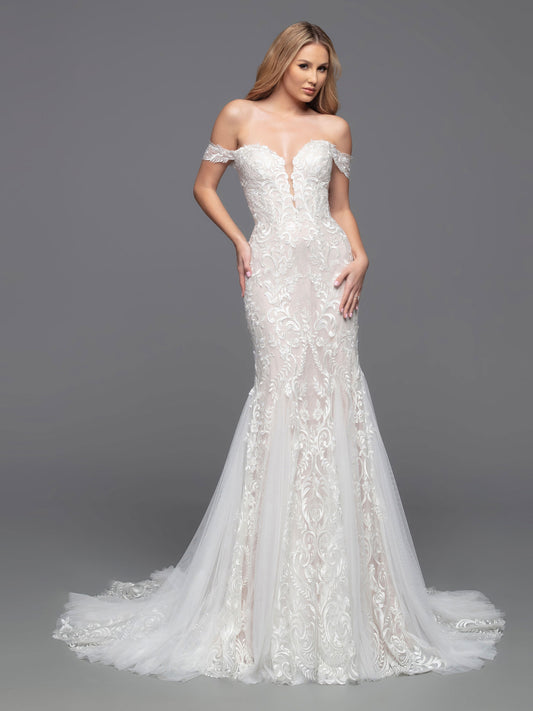 Look elegant and timeless in the Davinci Bridal 50812 Shimmer Lace Mermaid Wedding Dress. This luxurious gown features a lace bodice lined with sheer, off-the-shoulder sleeves, a sheer back, and covered buttons. Soft tulle, vertical lace panels and sheer lace panels enhance the design of this beautiful fit & flare gown, and a chapel train completes the look.  Sizes: 2-20  Colors: Ivory/Ivory, Ivory/Nude