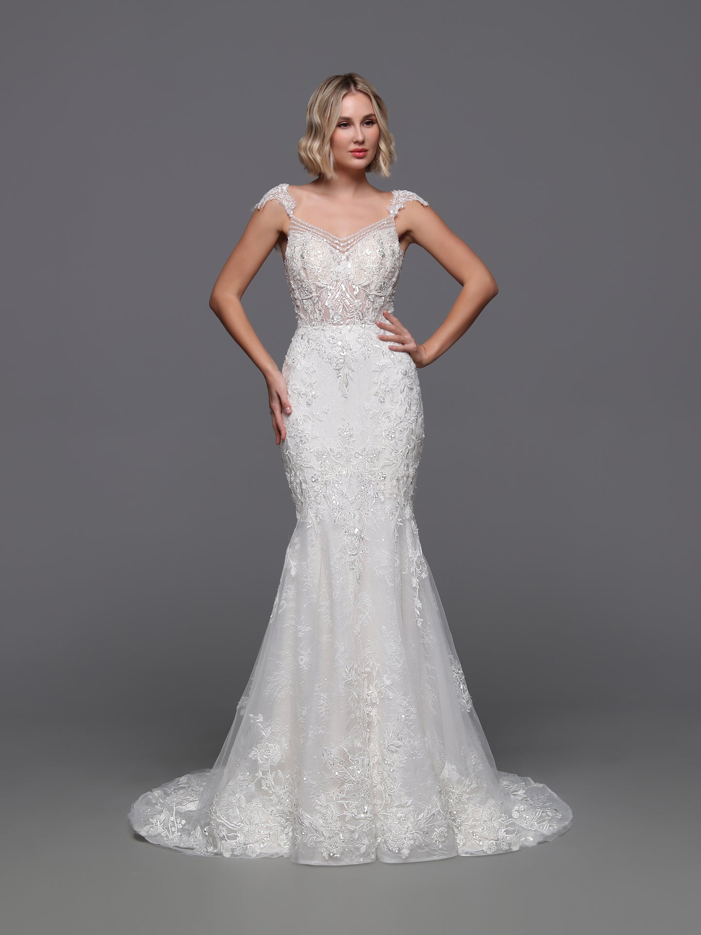 Experience the epitome of luxury with the Davinci Bridal 50875. This exquisite gown boasts a beaded sequin lace design, complemented by a detachable overskirt for added drama. The backless cut-out and beaded cap sleeves add a touch of sophistication to this elegant and exclusive wedding dress.