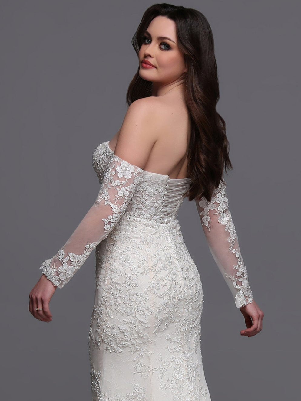 Indulge in elegance on your special day with the Davinci Bridal 50881 wedding dress. Flowing lace and intricate beading adorn the off the shoulder long-sleeves and corset back&nbsp; gown, leading into a stunning train. This mermaid-style dress is perfect for the modern bride who wants to make a statement. sequin shimmer