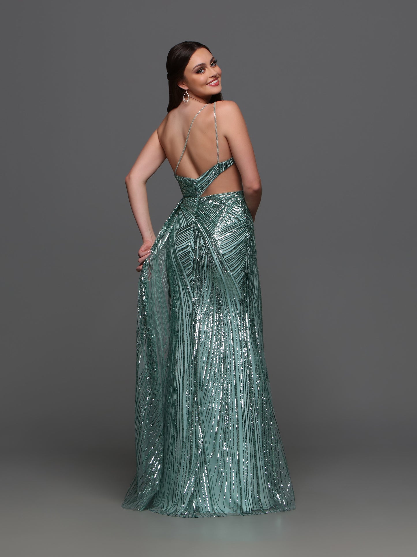 Elevate your formal look with the Candice Wang 72323 Sequin One Shoulder Cutout Dress. The sequin detailing adds a touch of glamour while the one shoulder and cutout design creates a sophisticated silhouette. The overskirt and maxi slit add a modern twist to this classic gown.  Sizes: 0-16  Colors: Sage