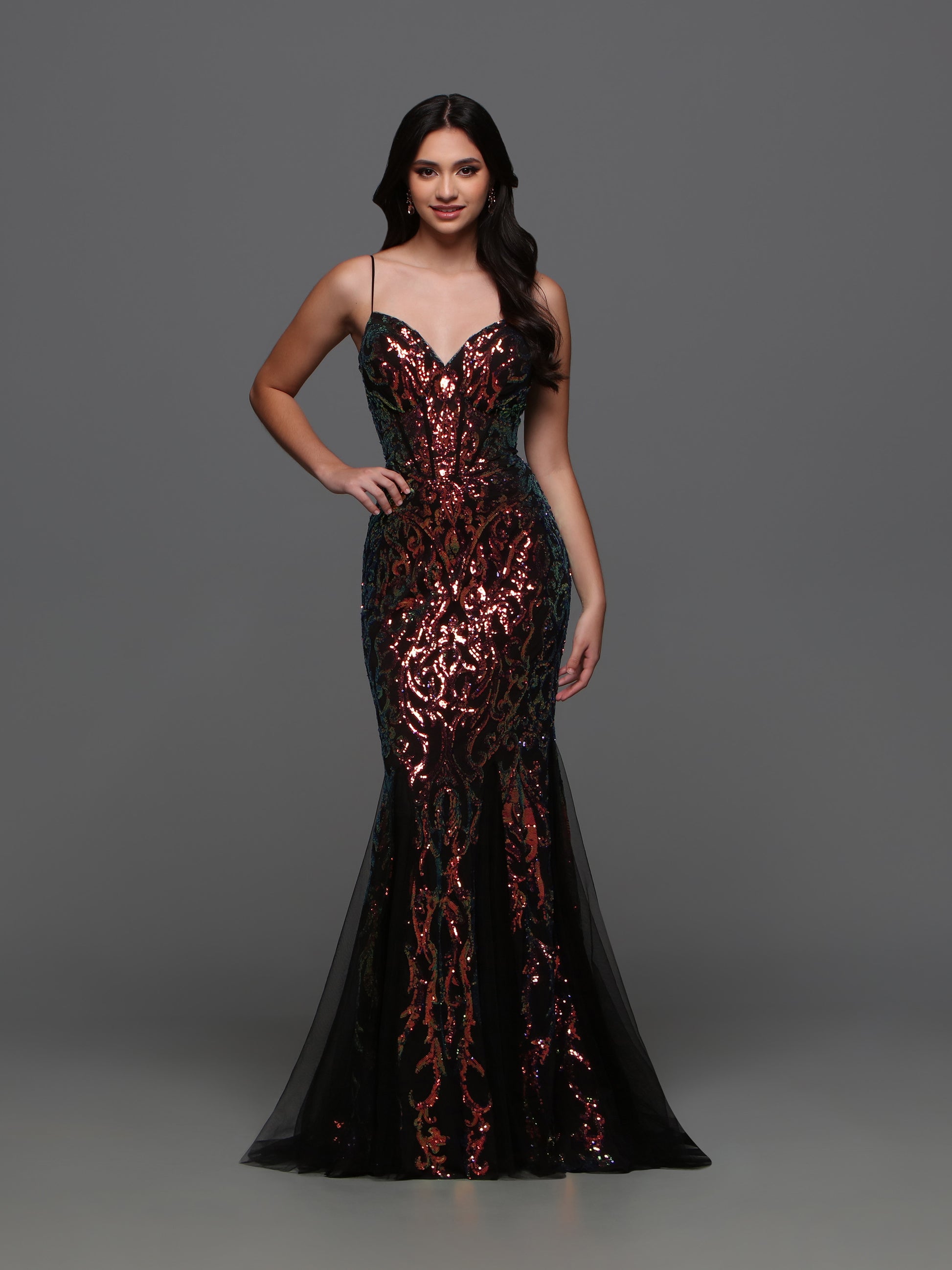 Crafted by designer Candice Wang 72338, this stunning evening gown features a sheer corset top with intricate sequin detailing. The tulle gusset and mermaid trumpet skirt add a touch of elegance and sophistication to any formal event. Be the belle of the ball in style and comfort.  Sizes: 0-12  Colors: Black Magic, Hot Pink