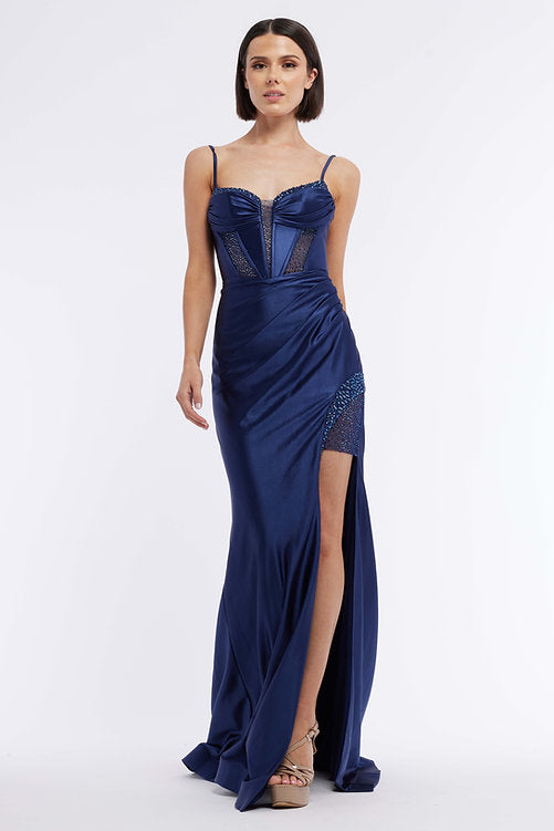 The Vienna Prom 7960 is an elegant evening gown featuring a long satin skirt, ruched bustier corset, and a dazzling crystal bodice – the perfect look for any pageant or formal occasion. The maxi slit design gives a subtle hint of sexiness that won't overpower the sophistication of this classic silhouette.