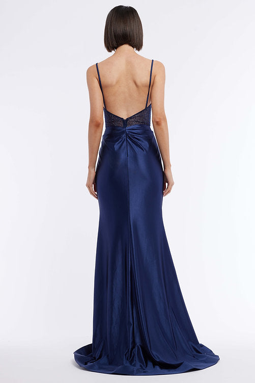 The Vienna Prom 7960 is an elegant evening gown featuring a long satin skirt, ruched bustier corset, and a dazzling crystal bodice – the perfect look for any pageant or formal occasion. The maxi slit design gives a subtle hint of sexiness that won't overpower the sophistication of this classic silhouette.