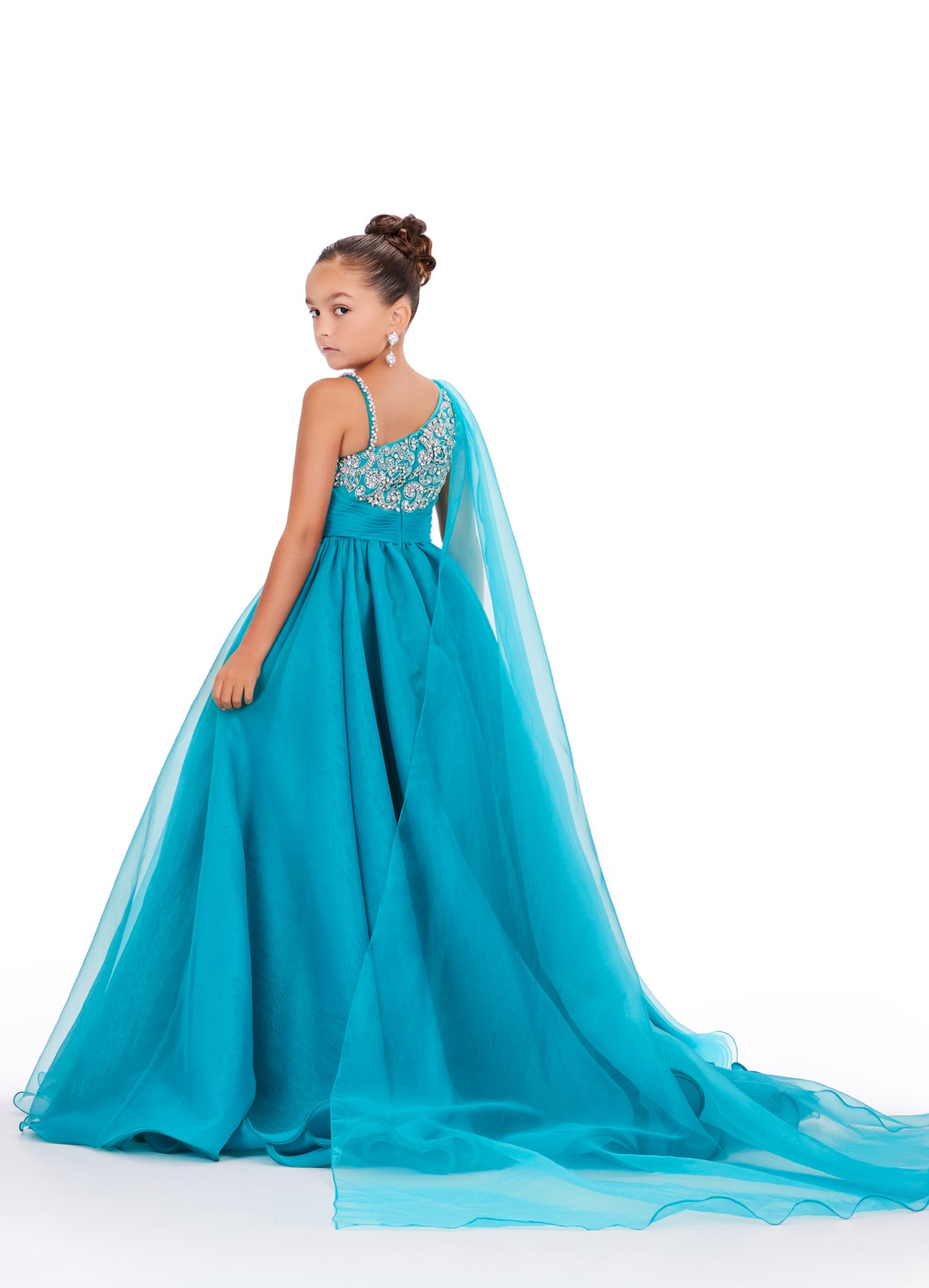 This Ashley Lauren Kids 8212 one-shoulder girls' pageant dress is both elegant and fun. With a cape design and crystal embellishments, this A-line ball gown is perfect for any pageant or special occasion. Look and feel like a princess in this stunning dress. This gorgeous organza ball gown is meant for a future queen! Featuring a stunning beaded bustier and one shoulder cape, this gown is sure to stun!