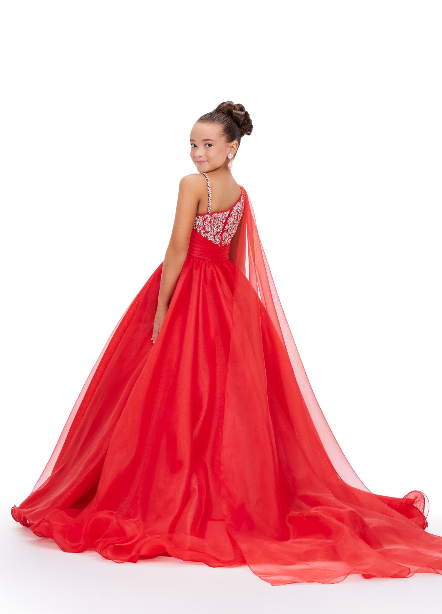 This Ashley Lauren Kids 8212 one-shoulder girls' pageant dress is both elegant and fun. With a cape design and crystal embellishments, this A-line ball gown is perfect for any pageant or special occasion. Look and feel like a princess in this stunning dress. This gorgeous organza ball gown is meant for a future queen! Featuring a stunning beaded bustier and one shoulder cape, this gown is sure to stun!