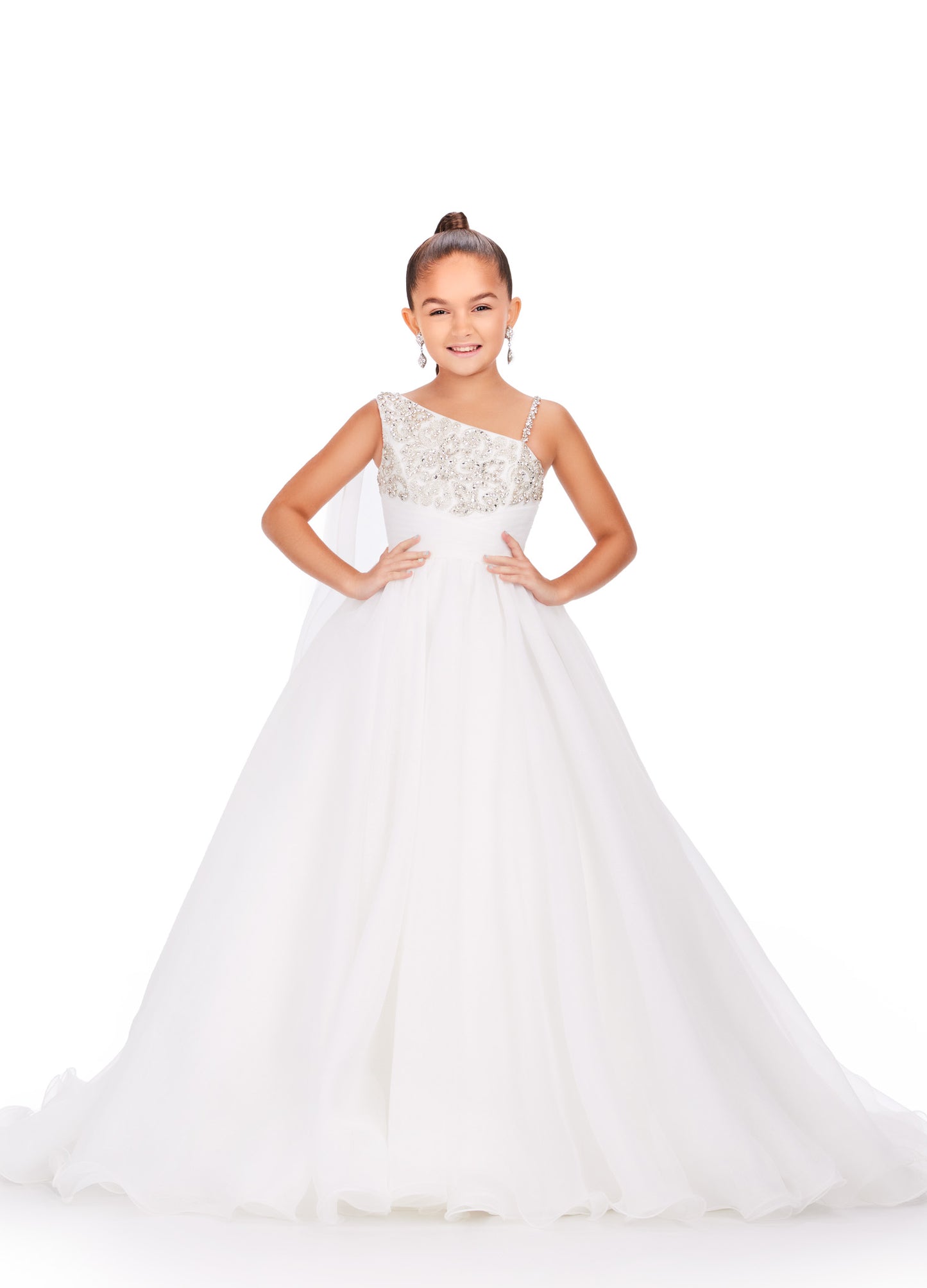 This Ashley Lauren Kids 8212 one-shoulder girls' pageant dress is both elegant and fun. With a cape design and crystal embellishments, this A-line ball gown is perfect for any pageant or special occasion. Look and feel like a princess in this stunning dress. This gorgeous organza ball gown is meant for a future queen! Featuring a stunning beaded bustier and one shoulder cape, this gown is sure to stun!