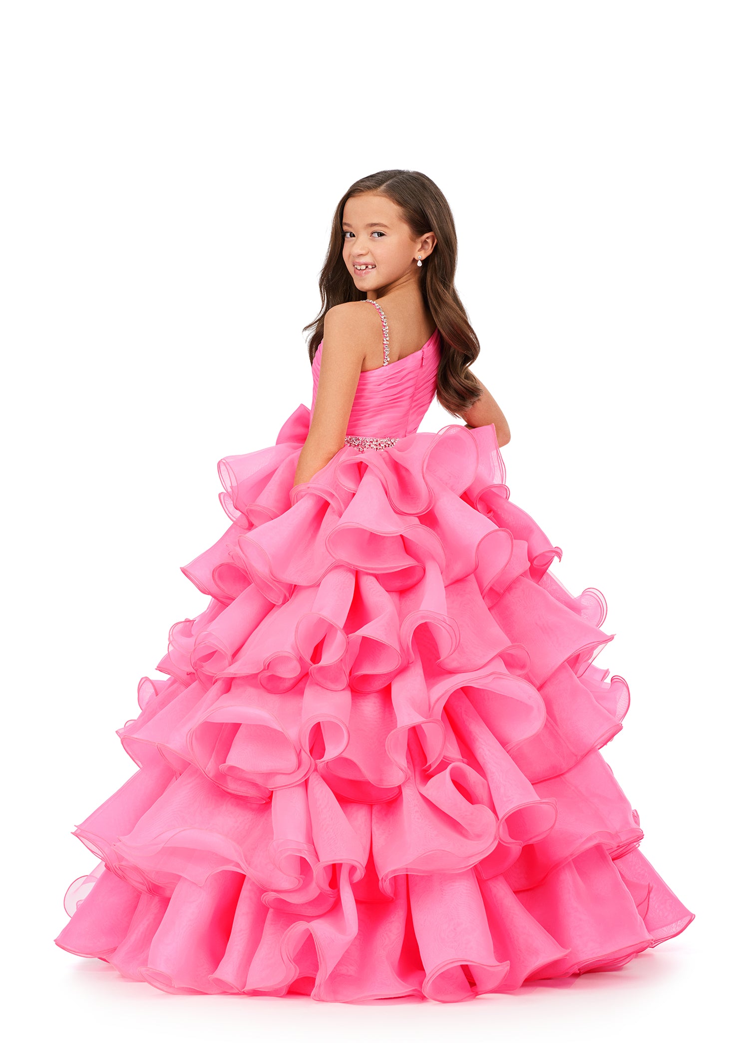 This Ashley Lauren Kids 8217 Long Ruffle Layer Girls Pageant Ballgown Bow Crystal Belt Gown is perfect for any special occasion! Elegantly crafted with an organza ball gown silhouette and one shoulder bustier, this dress also features beaded details along the waist line  and luxurious ruffles throughout the skirt. The waistband and shoulder strap are both beaded for added glam. One shoulder  Sizes: 4-16  Colors: Hot Pink, Aqua, Ivory