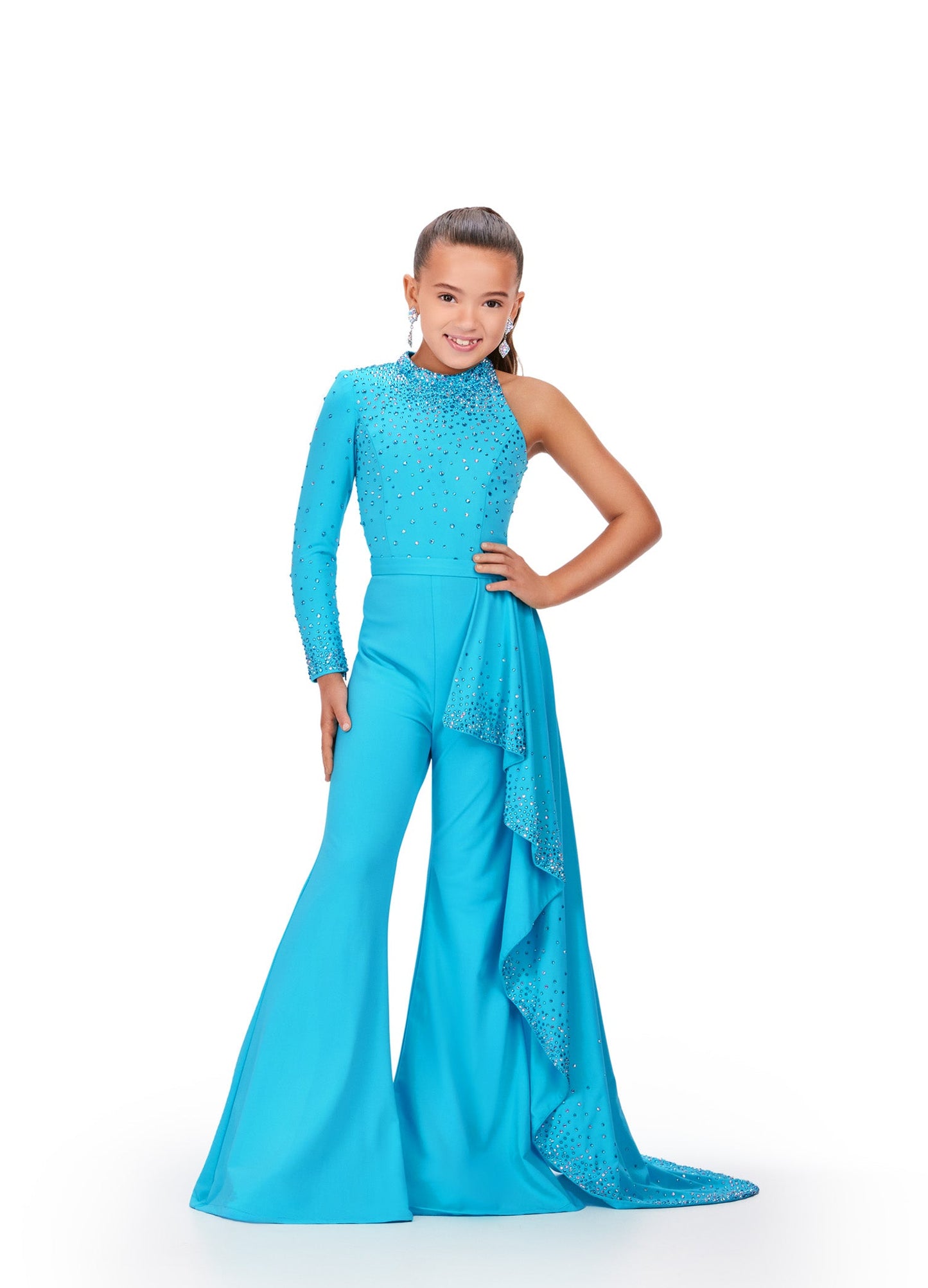 Presenting the Ashley Lauren Kids 8253 Girls Pageant Jumpsuit, featuring a stunning ruffle train and bell bottom pants. This elegant pant suit offers long sleeves for comfort and style, perfect for your little star's big moment. Elevate her confidence and charm on stage with this chic and timeless design. Bring the sass in this high neckline jumpsuit with one sleeve