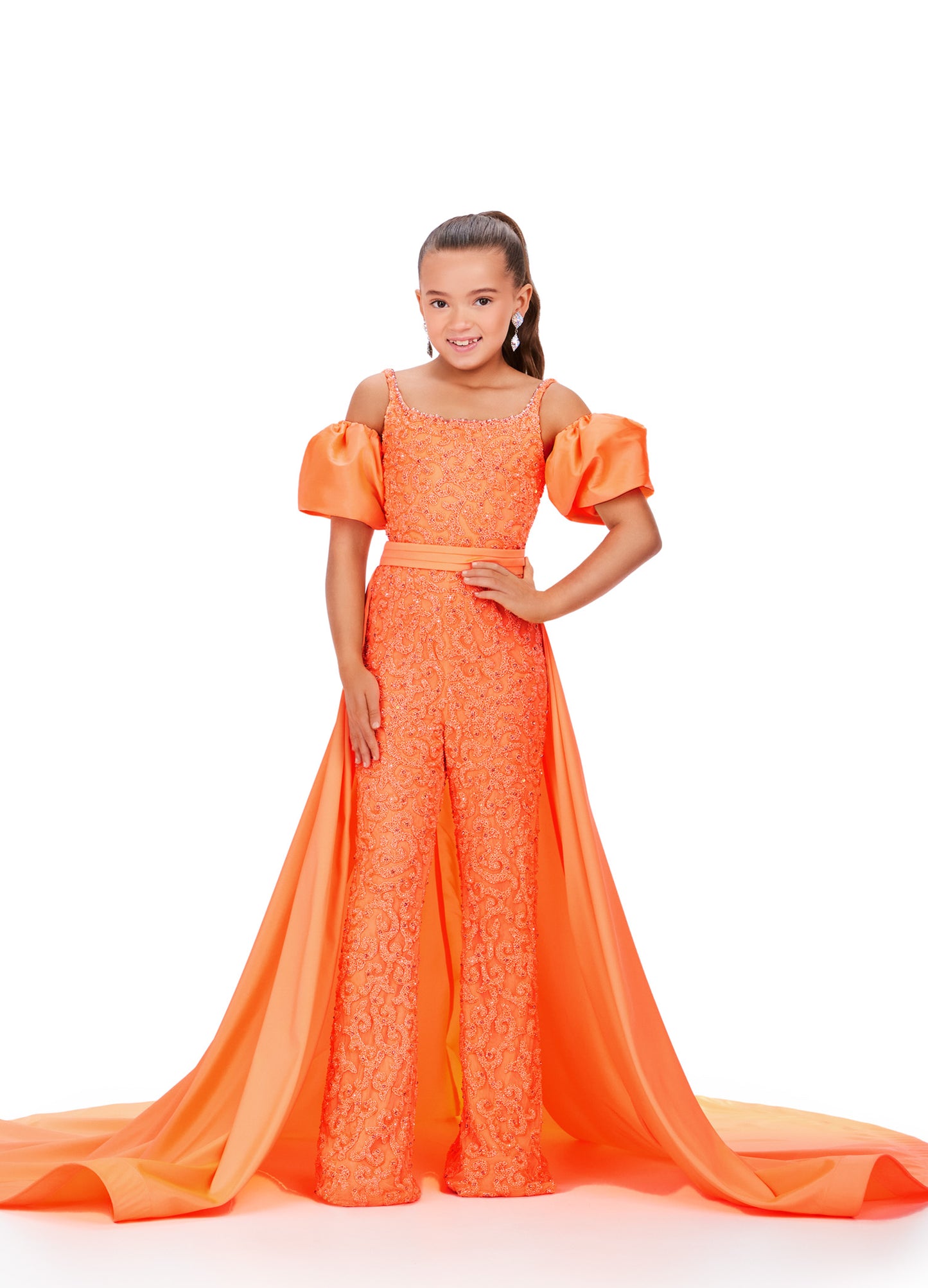 Introducing the Ashley Lauren Kids 8269 Girls Beaded Jumpsuit, the perfect combination of fun and elegance for your little one. Adorned with exquisite beading and a stylish overskirt, this jumpsuit is ideal for formal events and pageants. Enhance your child's fashion and confidence with this stunning piece