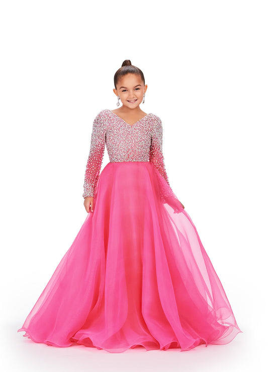 Elevate your little girl's style with this stunning Ashley Lauren Kids 8271 Pageant Dress. The intricate beaded details and long sleeve design add elegance and grace to the A-line silhouette, making her stand out on stage. Crafted with high-quality materials, this dress ensures unbeatable comfort and lasting wear. This elegant kids organza gown features a v-neckline with crystal and pearl details. The look is completed with long sleeves and an a-line skirt.