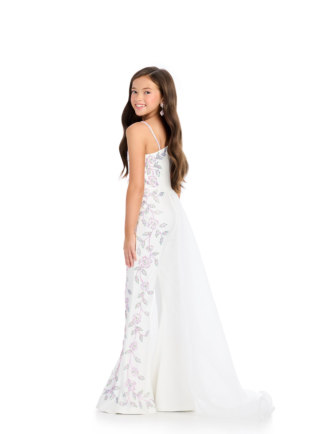 The Ashley Lauren 8274 Jersey Girls Jumpsuit is a stunning piece that features a unique embellished design with stones, combined with an elegant overskirt on one side. Perfect for making a statement at any event, this jumpsuit offers both style and comfort.