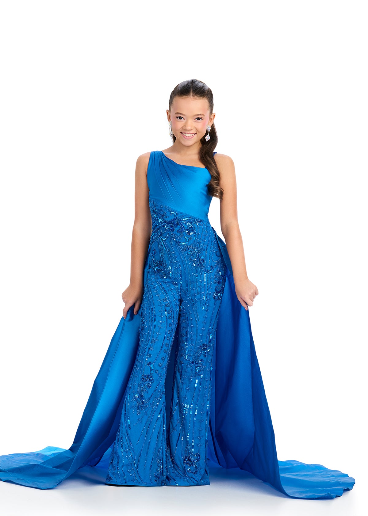 Elevate your little girl's style with the Ashley Lauren Kids 8287 Girls Pageant Jumpsuit. This fun and fashionable jumpsuit features intricate beading and a flowy overskirt for a glamorous look. Perfect for formal events, this jumpsuit will make your child feel confident and stylish. This taffeta jumpsuit is giving us all the glam! Featuring a one shoulder neckline and stunning beaded design, this look is complete with a sweeping train that takes our breath away!

One Shoulder
Fully Beaded Jumpsuit
Taffeta 