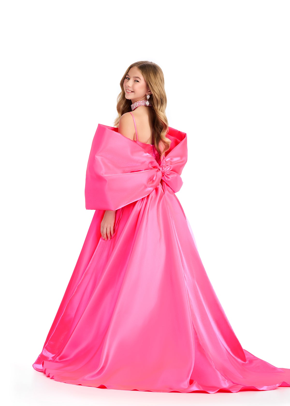 Introducing the Ashley Lauren Kids 8321 Oversize Bow Overskirt Pageant Accessory off the Shoulder Cape - the perfect addition to any pageant ensemble. The oversized bow and off the shoulder design add a touch of elegance and modernity to any outfit. Feel confident and glamorous on stage with this versatile accessory.&nbsp; Transform any outfit into a statement piece with this enchanting bow overskirt. This overskirt adds the perfect amount of glamour to any ASHLEYlauren cocktail dress, jumpsuit or dress.

B