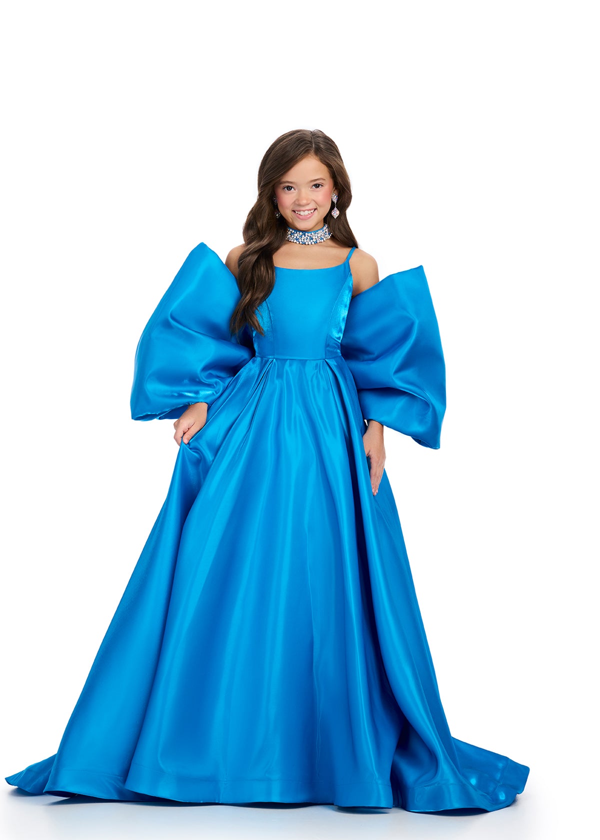 Introducing the Ashley Lauren Kids 8321 Oversize Bow Overskirt Pageant Accessory off the Shoulder Cape - the perfect addition to any pageant ensemble. The oversized bow and off the shoulder design add a touch of elegance and modernity to any outfit. Feel confident and glamorous on stage with this versatile accessory.&nbsp; Transform any outfit into a statement piece with this enchanting bow overskirt. This overskirt adds the perfect amount of glamour to any ASHLEYlauren cocktail dress, jumpsuit or dress.

B