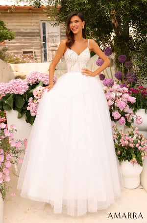 This Amarra 94020 spectacular tulle prom gown with a sweetheart neckline and beaded crystals will have you feeling like a princess for the night. Its color - white - is dazzling, and sparkles even more in the light of the beaded crystals that decorates the shimmering tulle skirt. Above the skirt, is the beautiful bodice designed delicately with sequins with sparse coloring of light blue, yellow and brown. 