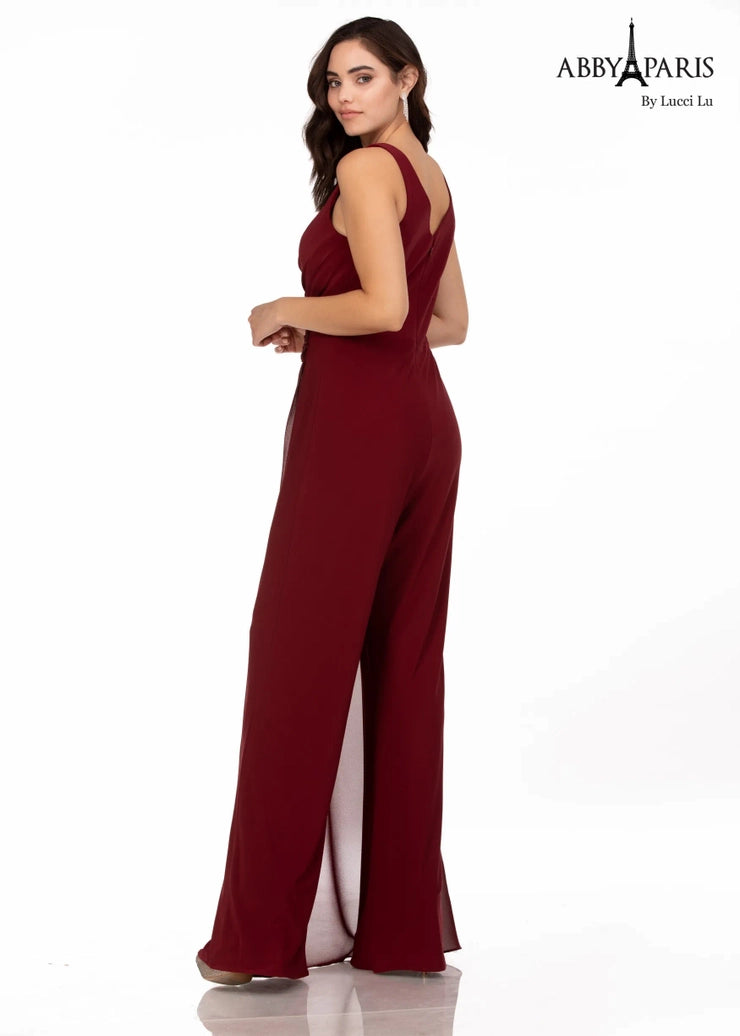 Make an unforgettable entrance in this Abby Paris 96064 jumpsuit. With an elegant v-neck bodice, ruching, and a sheer cape, this piece is designed to enhance your curves, while keeping you comfortable. A classic look that's perfect for any special occasion.