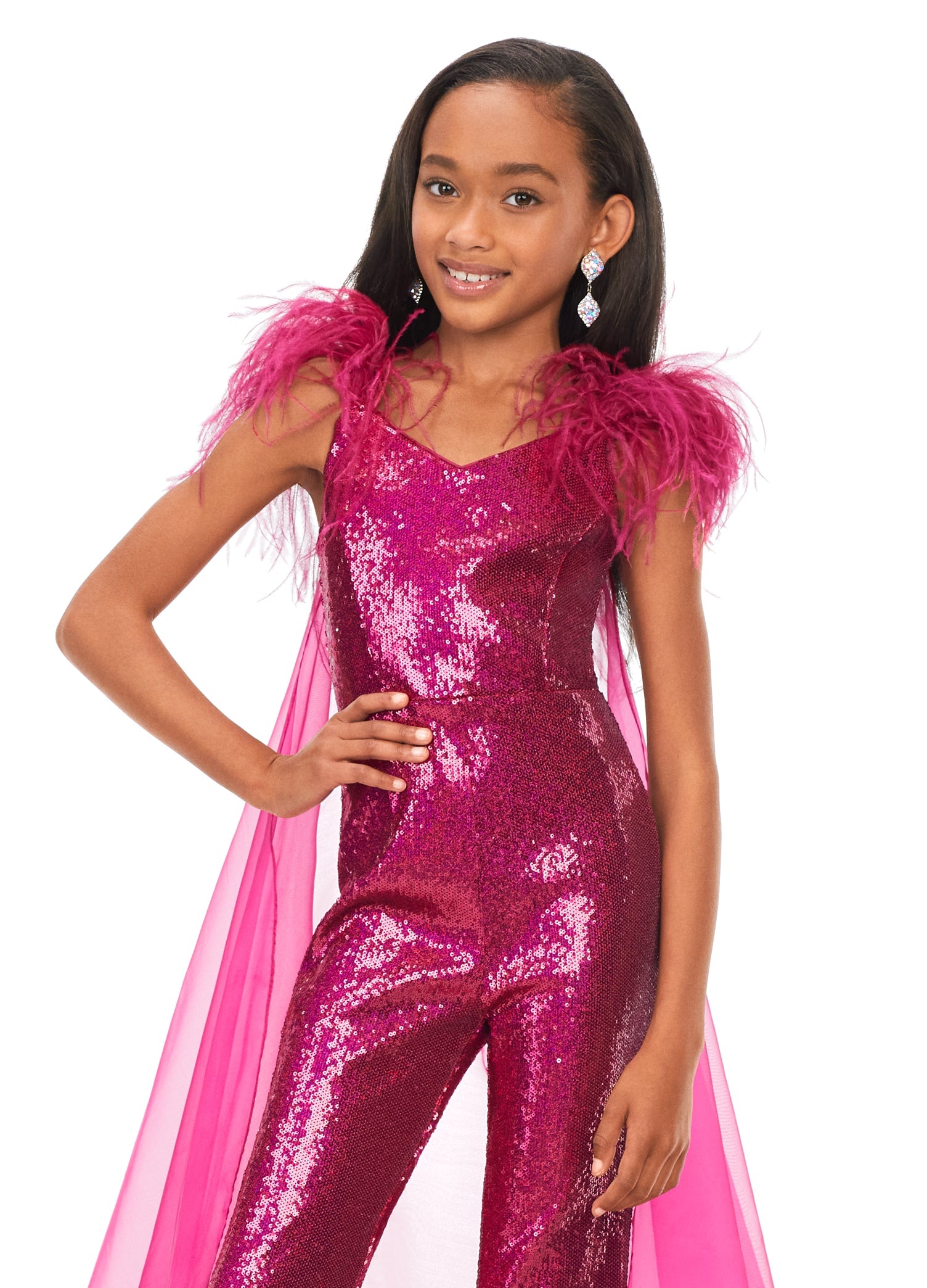 Ashley Lauren Kids 8174 Girls Sequin Jumpsuit with Organza Cape  Bring the drama in this kids sequin jumpsuit featuring a v-neckline. The look is complelted with an off the shoulder feather strap and organza cape.