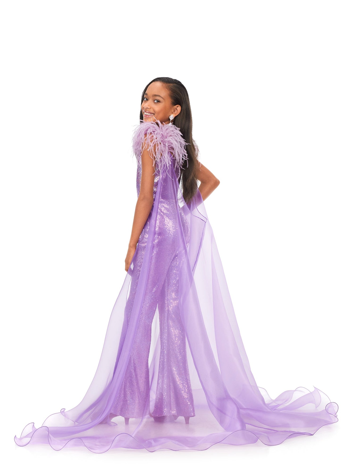 Ashley Lauren Kids 8174 Girls Sequin Jumpsuit with Organza Cape  Bring the drama in this kids sequin jumpsuit featuring a v-neckline. The look is complelted with an off the shoulder feather strap and organza cape.