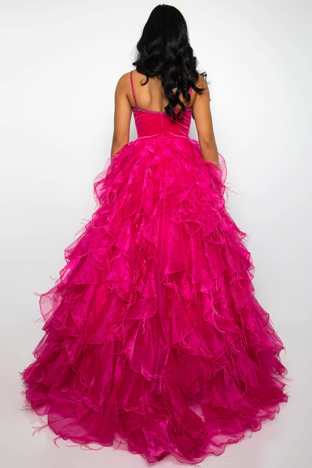 Experience glamour and sophistication in the Ava Presley 39554 Feather Velvet Dress. With its A-line silhouette, ruffle &amp; Feather ballgown with Rhinestone details, V-neckline, and luxurious velvet Bodice with Crystal accents, this dress is perfect for formal events such as pageants and prom. Get ready to turn heads and make a statement in this elegant and timeless piece.