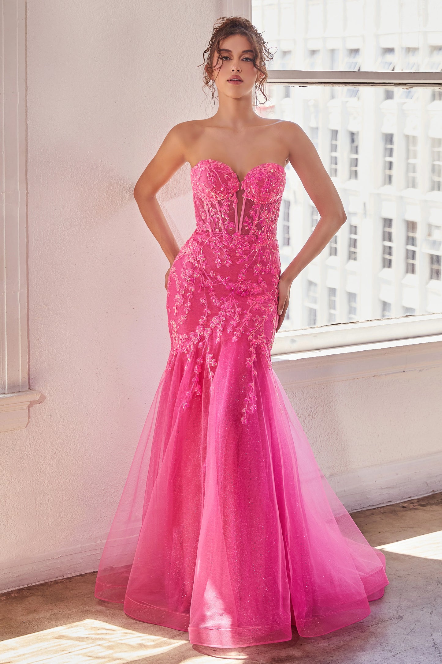 The Ladivine CB139 prom dress boasts a sheer corset bodice that adds a hint of allure to this shimmering dress. The mermaid silhouette and strapless design give a stunning, formal look that will turn heads. Perfect for prom or any special occasion. Look absolutely breathtaking in this beautiful strapless mermaid gown.