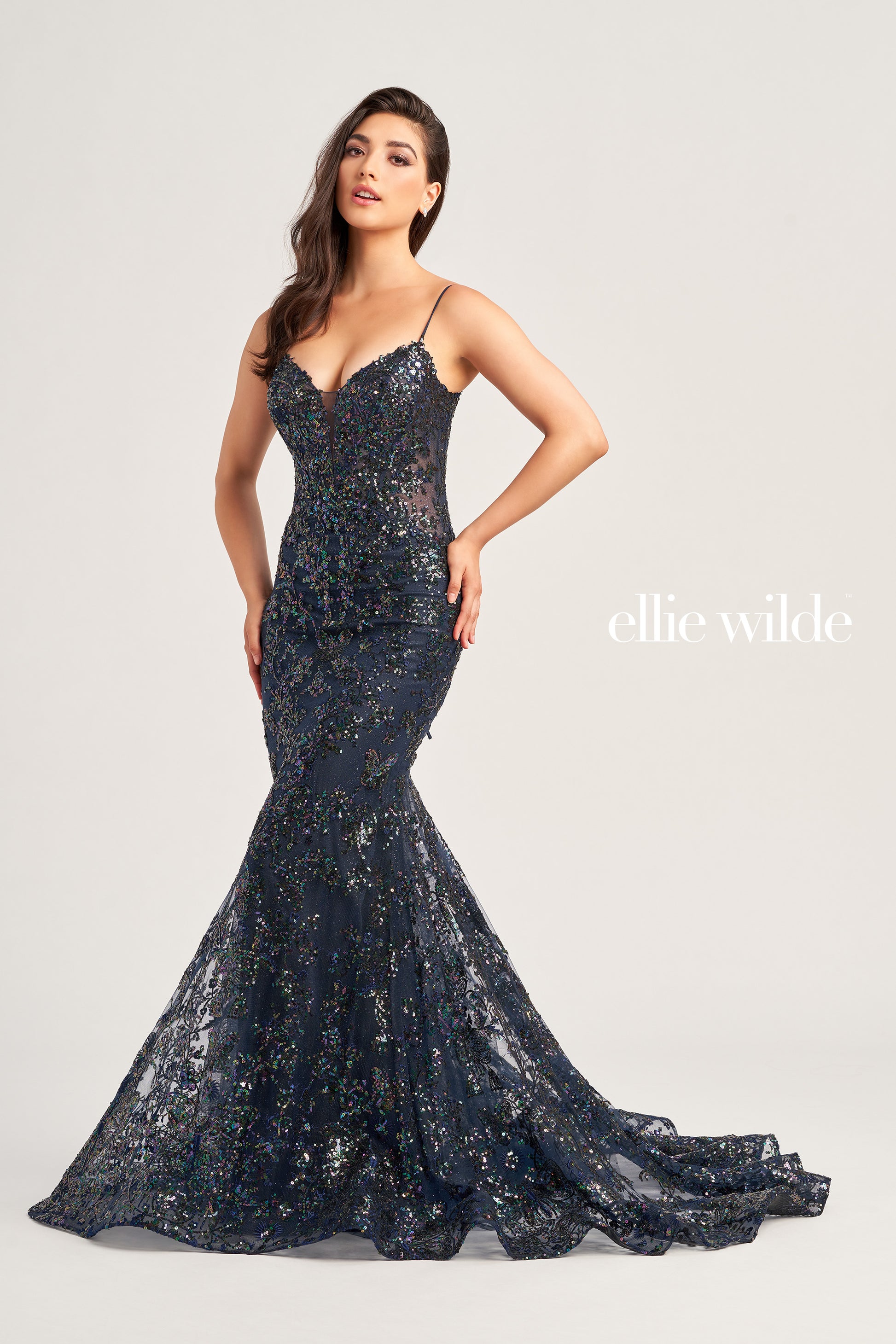 Make a stunning appearance at your next formal event in this Ellie Wilde EW35013 Long Fitted Sequin Mermaid Prom Dress. Crafted from an exquisite combination of Embroidered Tulle, Glitter Tulle, and Sequins, this beautiful dress includes a plunging Sweetheart neckline, a corset bodice with a lace-up back, and a trumpet silhouette for the perfect fit. The Natural waistline and Sleeveless design complete the look.  COLOR: BLACK, MIDNIGHT, LIGHT BLUE, LILAC, HOT PINK SIZE: 00 - 20