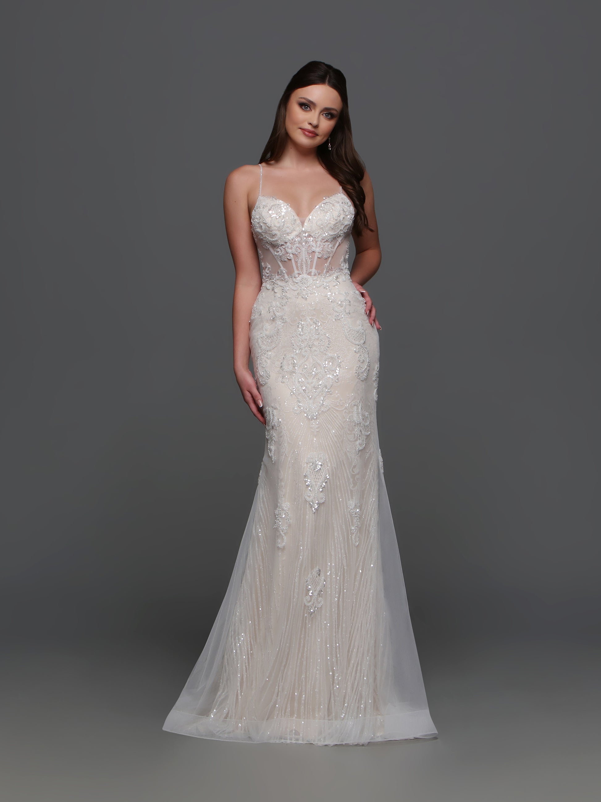 Elevate your wedding day look with the F123 Long Beaded Sheer Wedding Dress by Davinci Bridal. Featuring a mermaid silhouette and shimmering beadwork, this gown exudes luxury and sophistication. The sheer detailing and V-neckline add an elegant touch, making you the center of attention on your special day. A lovely blend of visual textures, this wedding dress features a sheer beaded lace applique bodice and a linear-pattern tulle skirt with a sheer overskirt with lace that matches the bodice.