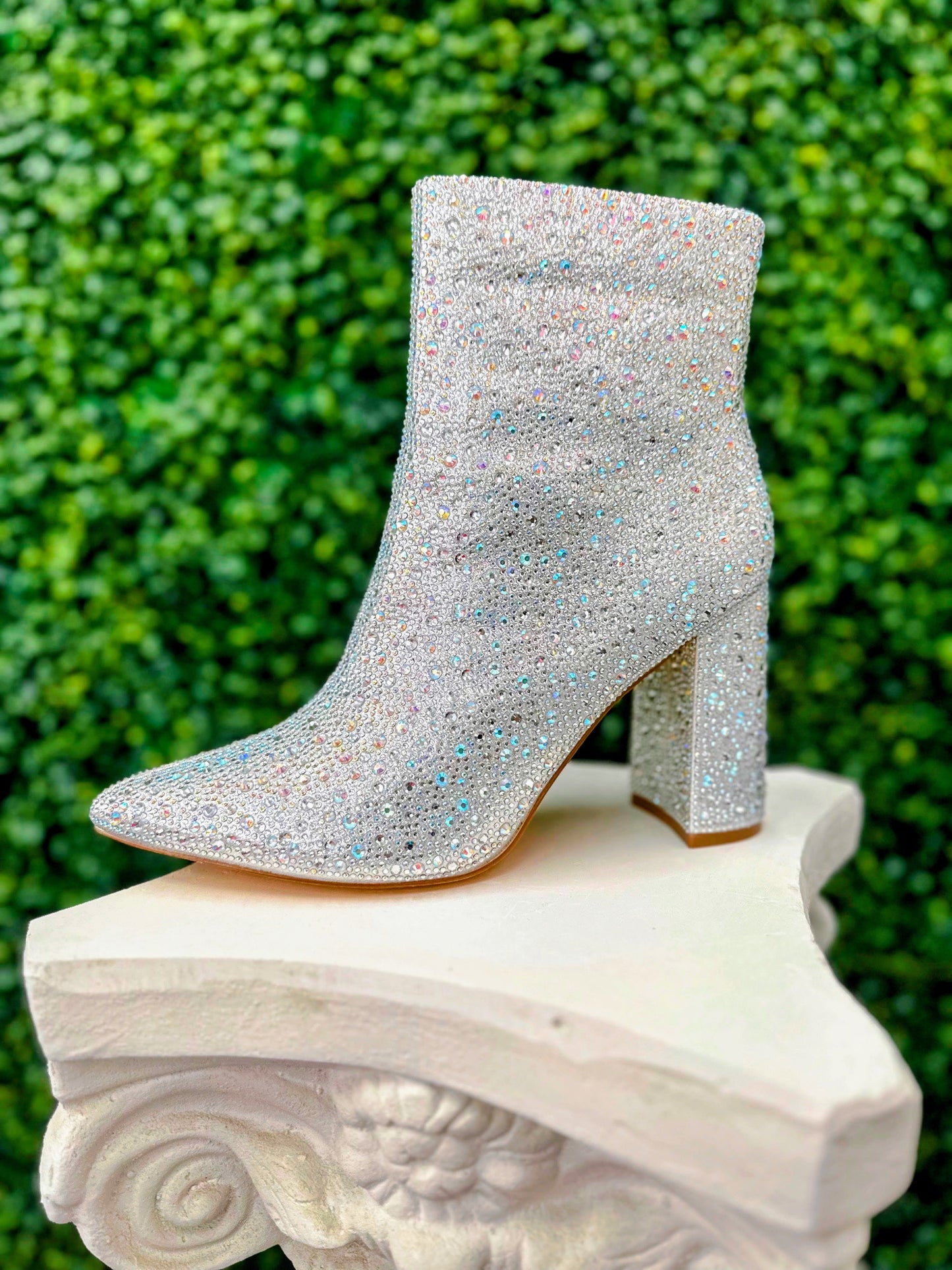 Expertly crafted to add a touch of elegance to any formal event, the De Blossom Melani Crystal Shimmer Formal Shoe is a must-have for any fashion enthusiast. Featuring a sleek block heel adorned with a variety of crystal sizes and a convenient zip up back, these ankle boots are perfect for proms, pageants, or any evening affair.