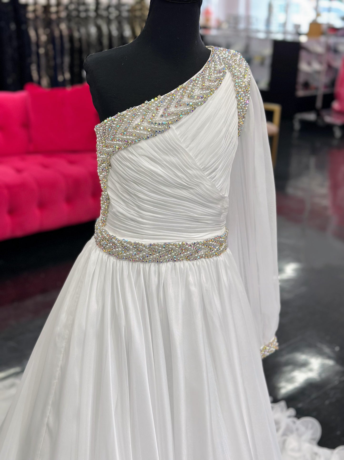 Be the epitome of grace and elegance in the Samantha Blake 1014 one shoulder Long Sleeve Pageant Dress. Made with delicate chiffon and a stunning crystal embellished bodice, this dress features a one-shoulder design and long sleeves for a sophisticated look. Perfect for any pageant or formal event.