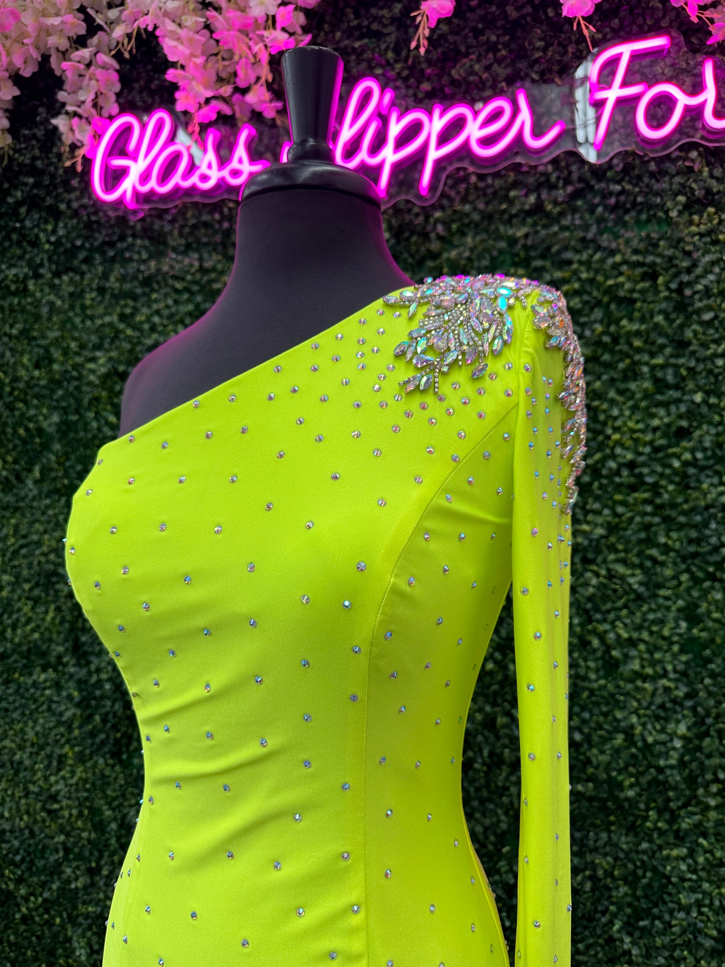 This Johnathan Kayne 2785 dress is perfect for your homecoming event. It features a single crystal shoulder, long sleeve with crystal wrist line, and stoned bodice for a sparkling look. It is also fitted for a flattering silhouette. Perfect for a memorable night.  Sizes: 4  Colors: Neon Green