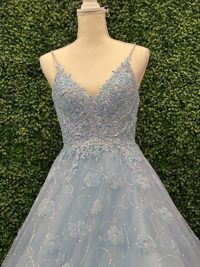 This Blue Sequin Lace Shimmer Ballgown by Johnathan Kayne features high quality sequin detailing on the bodice and skirt to create a dramatic and eye-catching look. The sleeveless bodice has a modest neckline, while the floor-length skirt adds elegance and movement for the perfect prom dress. 3d Floral Tulle Appliques and sequins cascading down the skirt.  *** One of A KIND!  Size: 4  Color: Light Blue