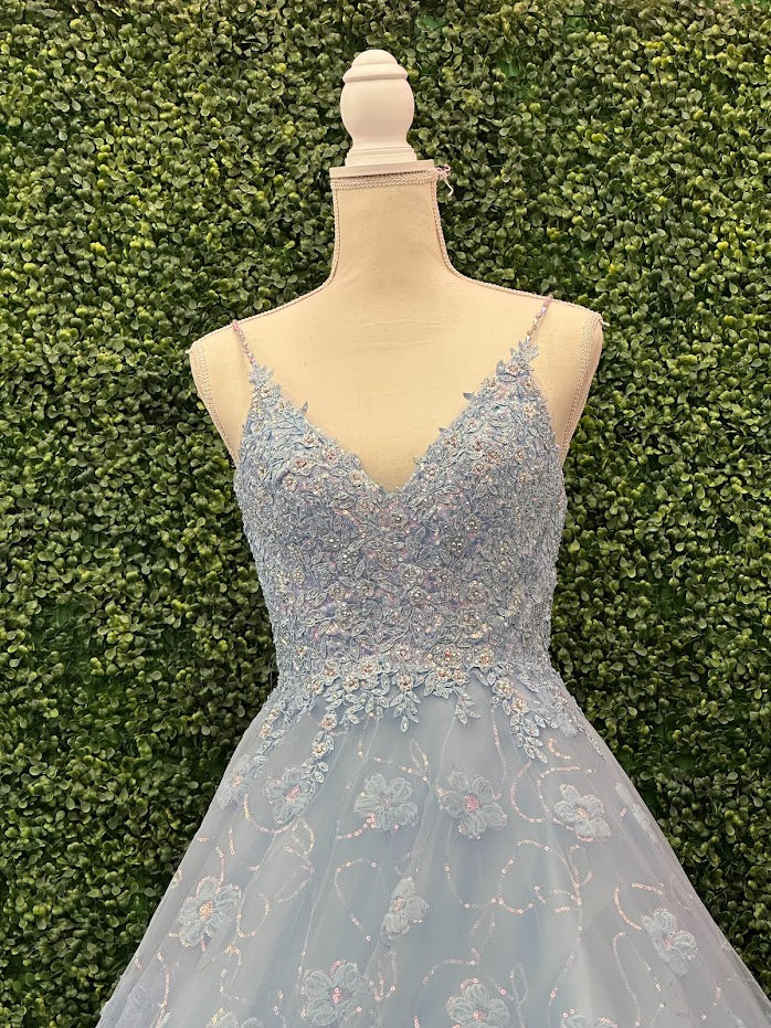 This Blue Sequin Lace Shimmer Ballgown by Johnathan Kayne features high quality sequin detailing on the bodice and skirt to create a dramatic and eye-catching look. The sleeveless bodice has a modest neckline, while the floor-length skirt adds elegance and movement for the perfect prom dress. 3d Floral Tulle Appliques and sequins cascading down the skirt.  *** One of A KIND!  Size: 4  Color: Light Blue