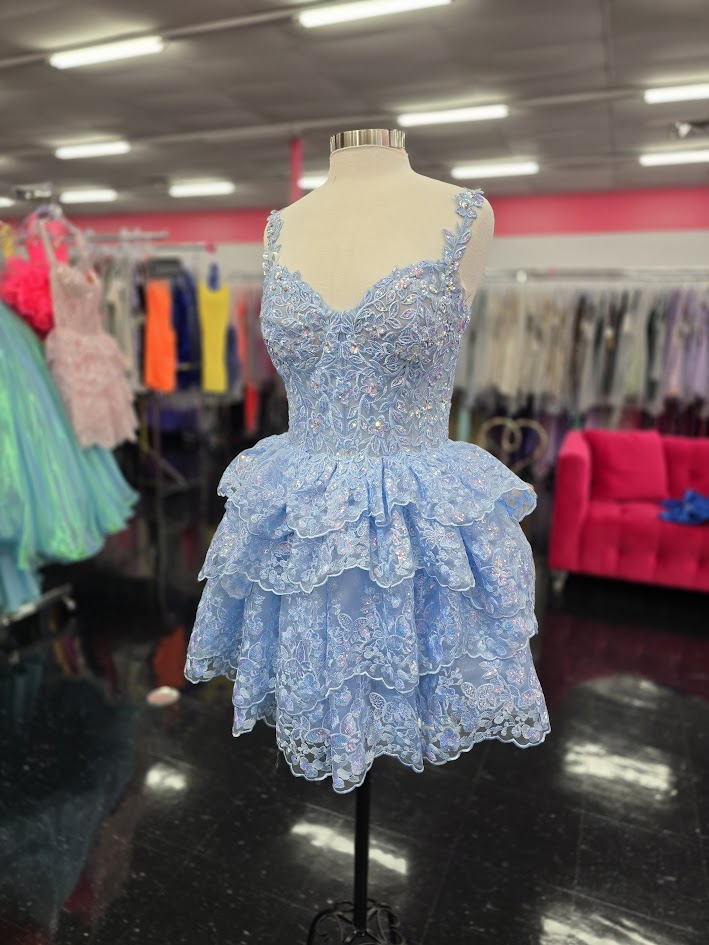 Upgrade your homecoming style with the Jovani 37080 Short Lace Ruffle Dress. The sequin embellished lace corset and asymmetrical layered short skirt create a chic silhouette, perfect for a night out. Stand out in this elegant and trendy cocktail dress. This Cocktail Dress is perfect for any formal occasion!