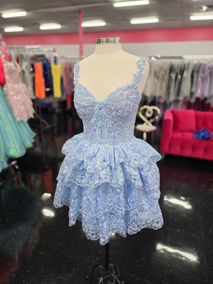 Upgrade your homecoming style with the Jovani 37080 Short Lace Ruffle Dress. The sequin embellished lace corset and asymmetrical layered short skirt create a chic silhouette, perfect for a night out. Stand out in this elegant and trendy cocktail dress. This Cocktail Dress is perfect for any formal occasion!