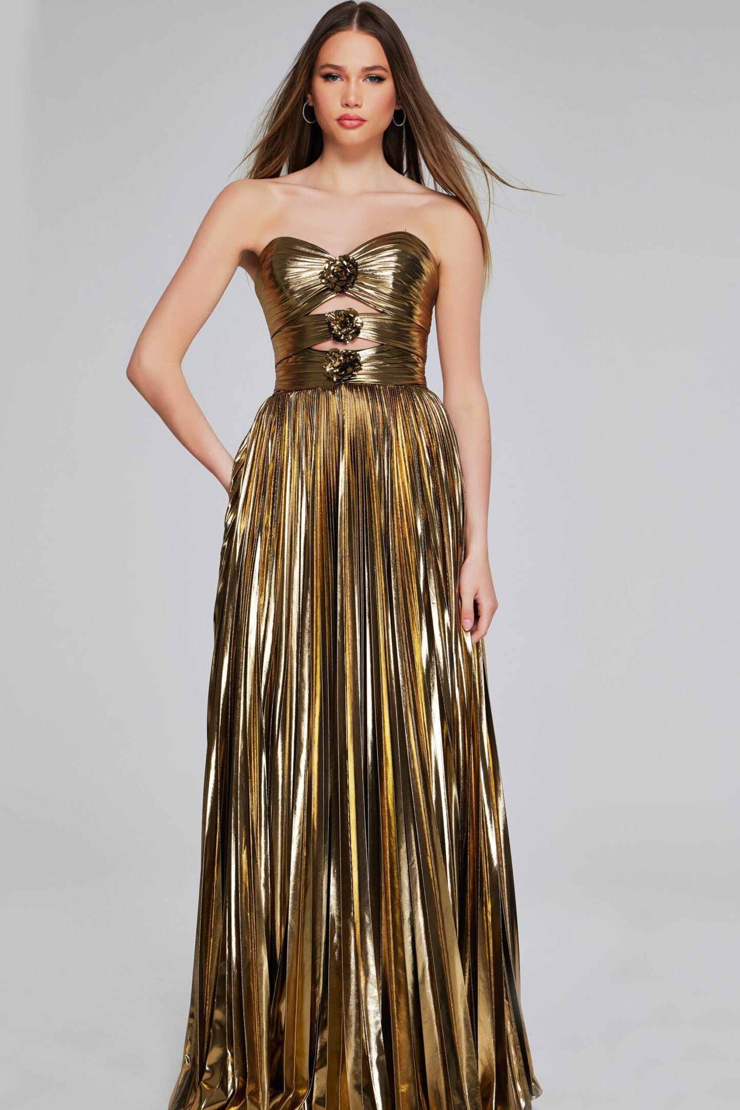 Dazzle in this stunning Jovani 42335 Pleated Metallic Strapless Dress. With intricate pleating and a cut-out design, this elegant dress exudes sophistication. Perfect for a formal event or prom, its metallic fabric catches the light for a sparkling effect. Stun in this figure-flattering gown and make a statement.