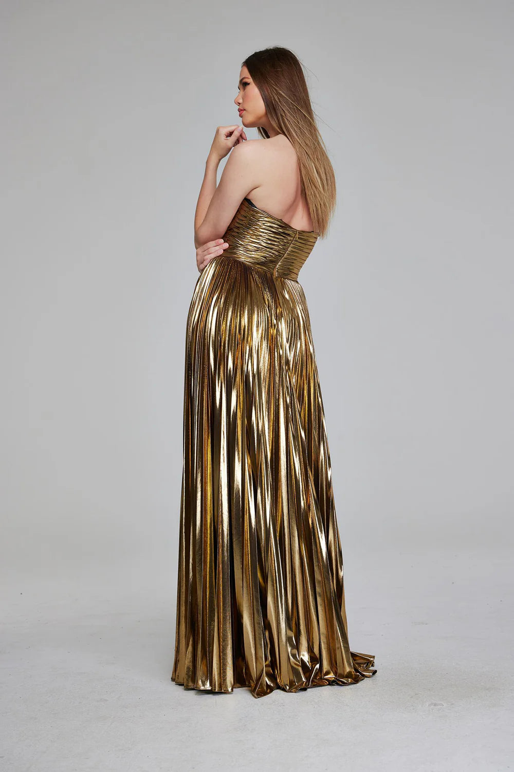 Dazzle in this stunning Jovani 42335 Pleated Metallic Strapless Dress. With intricate pleating and a cut-out design, this elegant dress exudes sophistication. Perfect for a formal event or prom, its metallic fabric catches the light for a sparkling effect. Stun in this figure-flattering gown and make a statement.