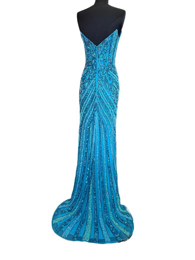 The Jovani 38707 prom dress is a stunning and sophisticated gown designed for formal occasions, making it a perfect choice for prom. This floor-length dress is made from delicate mesh fabric, which gives it a lightweight and semi-transparent quality, adding a touch of elegance to the overall look.