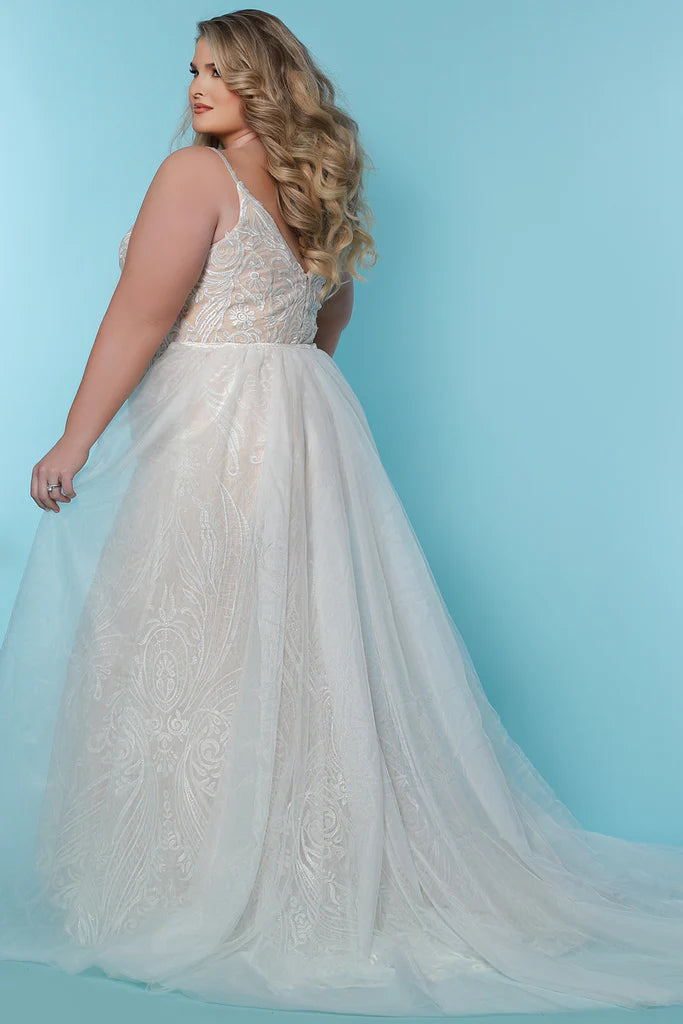 Sydneys Coset SC5287 Jolene Plus Size Bridal Dress. The Sydneys Coset SC5287 Jolene Plus Size Bridal Dress features an opulent, intricate bodice and cascading layers of matte chiffon on the skirt. Its timeless silhouette is cut to flatter the female form, and create an elegant statement as you take your place at the altar. This exquisite dress is designed exclusively for the plus size bride and is sure to make a lasting impression on your special day.