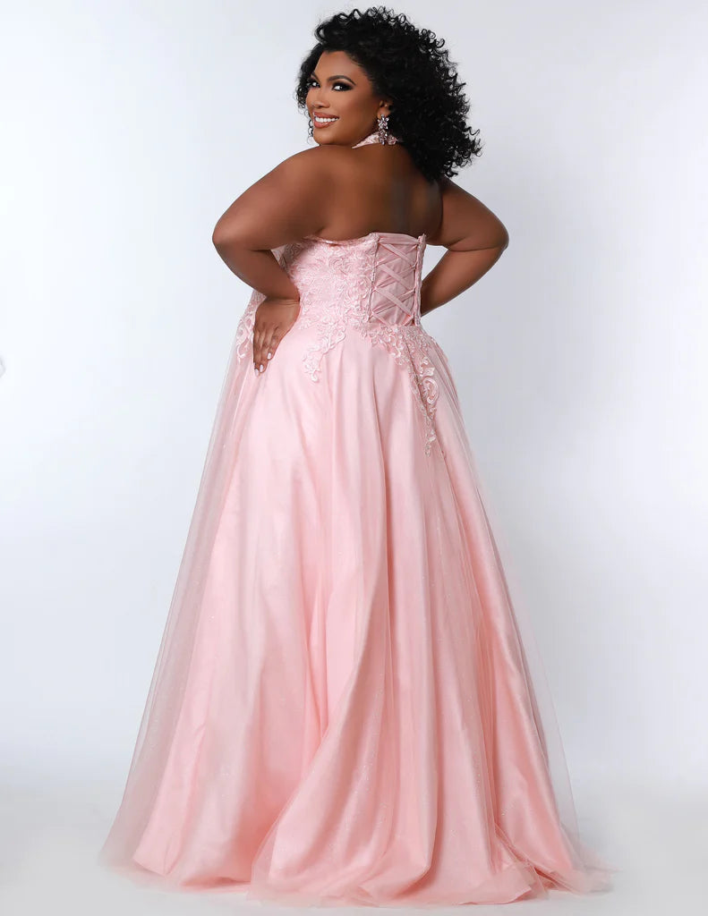 Sydney's Closet SC7352 A-Line Glitter Tulle Lace Appliques Lace Up Back Halter Neckline Plus Size Prom Dress. The Sydney's Closet SC7352 A-Line Glitter Tulle Lace Appliques Plus Size Prom Dress makes a glamorous addition to your wardrobe. This chic dress features an A-line silhouette, glitter tulle overlay, and delicate lace appliques - all crafted with an adjustable lace-up back and halter neckline. An elegant choice for formal occasions.