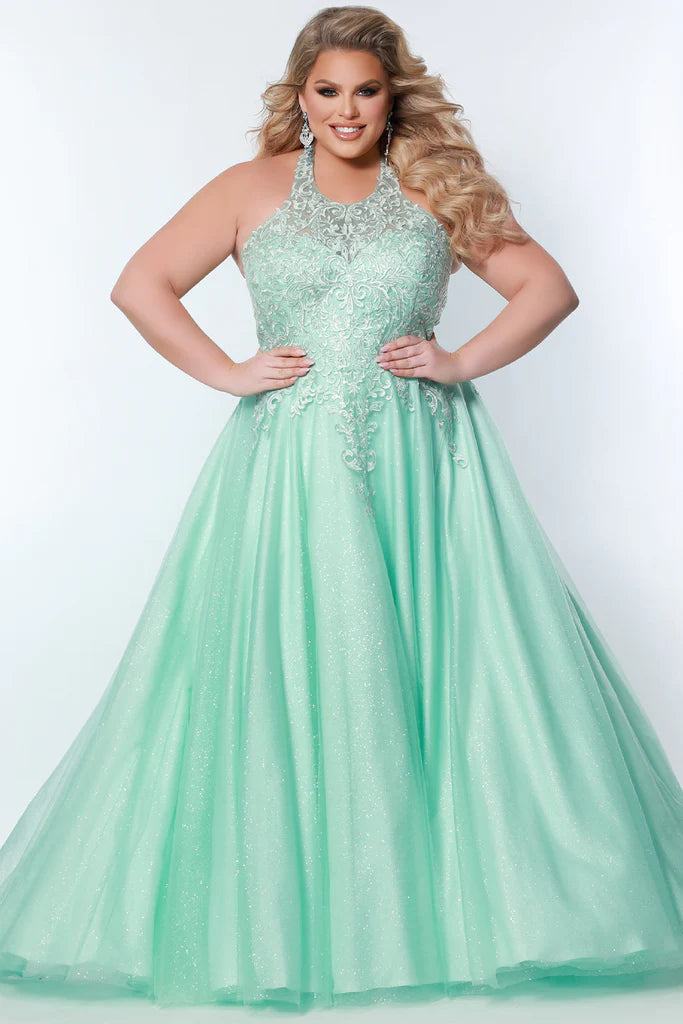 Sydney's Closet SC7352 A-Line Glitter Tulle Lace Appliques Lace Up Back Halter Neckline Plus Size Prom Dress. The Sydney's Closet SC7352 A-Line Glitter Tulle Lace Appliques Plus Size Prom Dress makes a glamorous addition to your wardrobe. This chic dress features an A-line silhouette, glitter tulle overlay, and delicate lace appliques - all crafted with an adjustable lace-up back and halter neckline. An elegant choice for formal occasions.