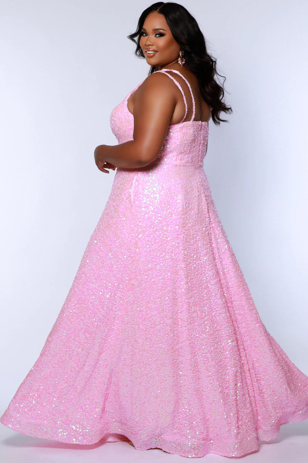 Be the belle of the ball in Sydneys Closet SC7365 Long Prom Dress. This plus size formal dress features an all-over sequin bodice with a scoop neckline, and a gathered A-line skirt with pockets. Perfect for prom nights, the elegant style of this gown will make you feel like a star.