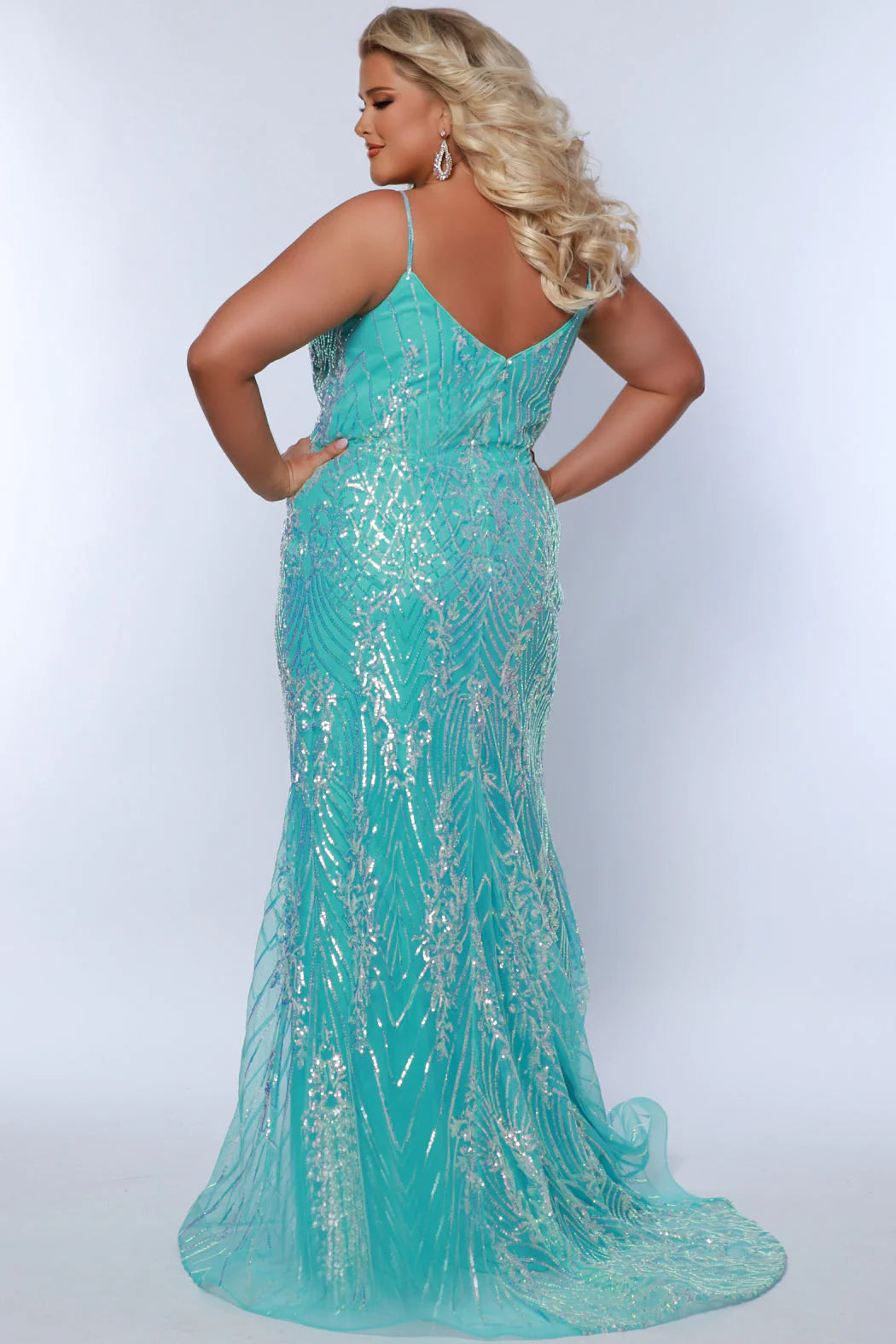 Look beautiful and timeless in this Sydneys Closet SC7366 Long Prom Dress. The fitted plus size gown is embellished with dazzling sequins and a graceful train. Perfect for your next formal event, this elegant dress is sure to make you the bright star of the night. Look glamorous on your big night in this sexy fitted Trumpet gown.