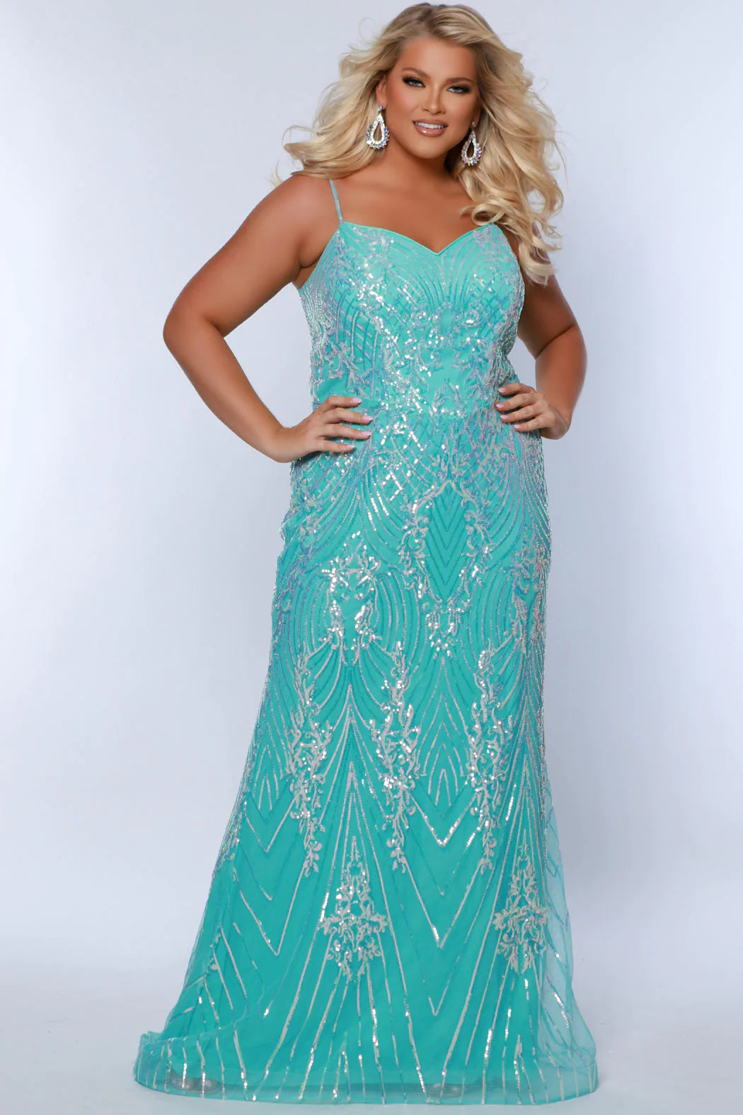 Look beautiful and timeless in this Sydneys Closet SC7366 Long Prom Dress. The fitted plus size gown is embellished with dazzling sequins and a graceful train. Perfect for your next formal event, this elegant dress is sure to make you the bright star of the night. Look glamorous on your big night in this sexy fitted Trumpet gown.