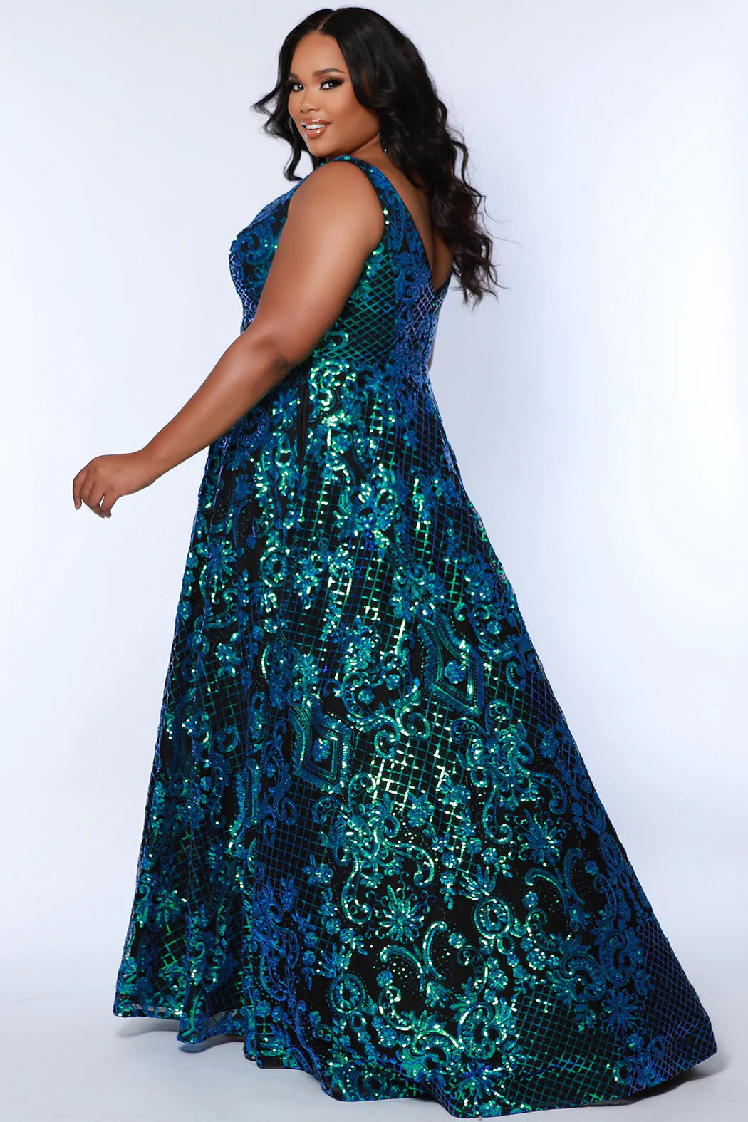 This elegant, plus size Sydneys Closet SC7367 Long Prom Dress features a V-neckline, sequins, pockets, and a long train--all crafted from a luxurious fabric for a stylish and comfortable look. Its timeless design makes it perfect for formal occasions. Make a trendy fashion statement at Prom or any formal when you wear this eye-catching plus size evening dress. 