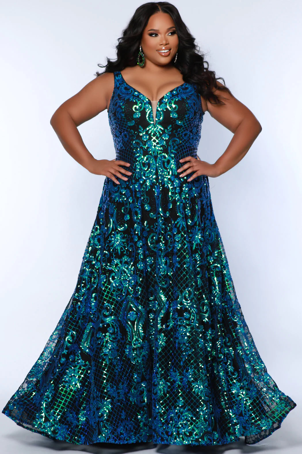 This elegant, plus size Sydneys Closet SC7367 Long Prom Dress features a V-neckline, sequins, pockets, and a long train--all crafted from a luxurious fabric for a stylish and comfortable look. Its timeless design makes it perfect for formal occasions. Make a trendy fashion statement at Prom or any formal when you wear this eye-catching plus size evening dress. 