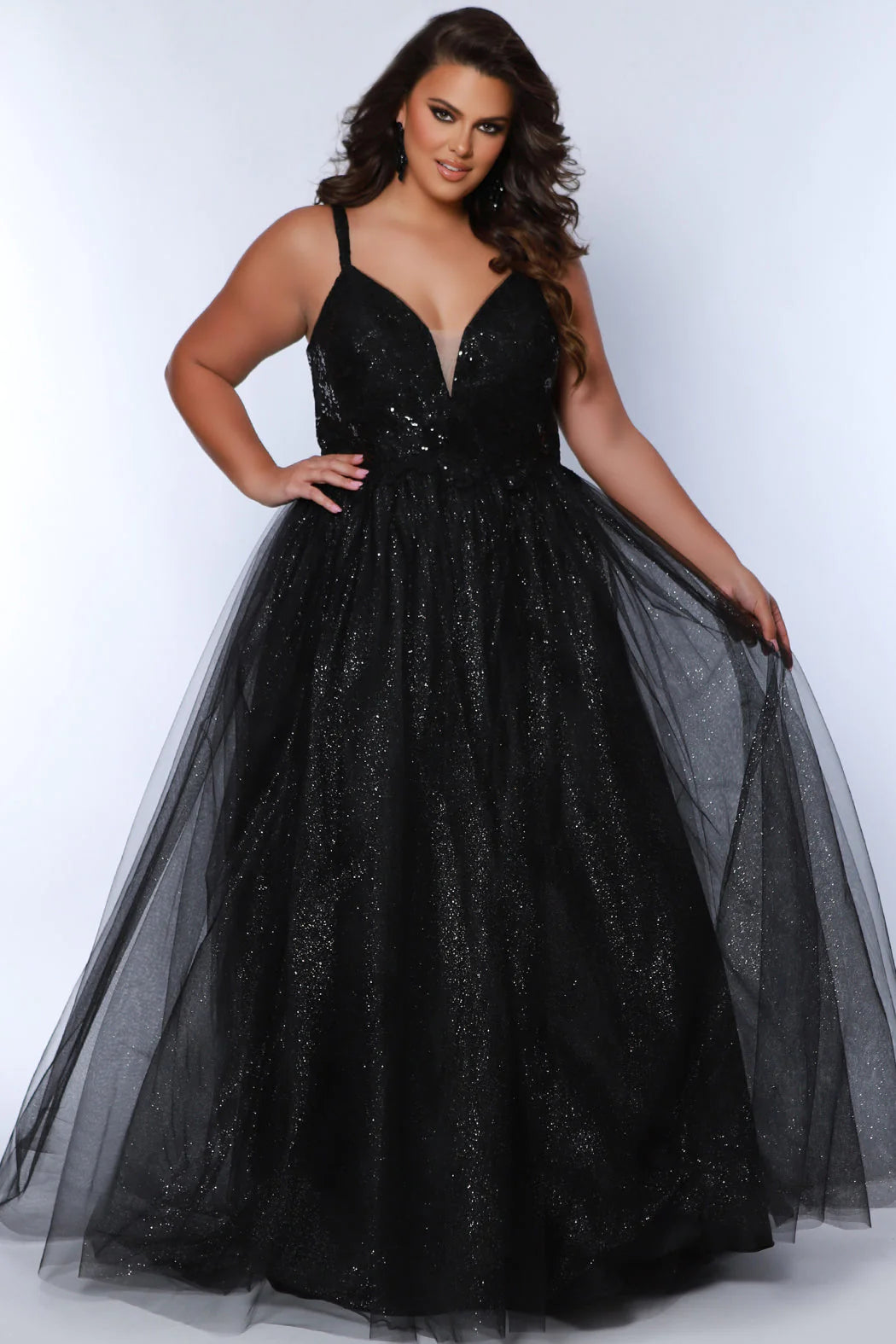 This plus-size evening gown from Sydneys Closet features a glamorous sequin-encrusted bodice, a V-neckline, and an A-line skirt for a modern, flattering silhouette. Crafted from luxurious fabrics, this formal gown is perfect for special occasions. 